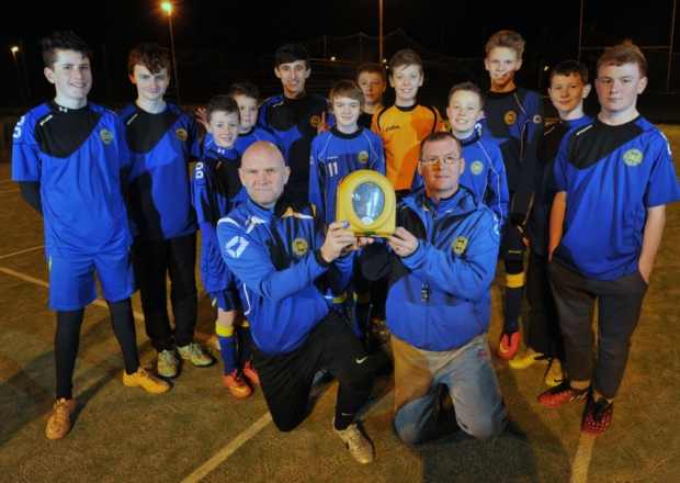 Coaches and players at Kirkliston and South Queensferry Football Club with their new HeartSine defibrillator. Photo courtesy: Ian Rutherford