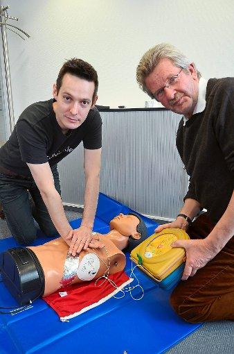 Left to right: Paramedic Benjamin Talmon l'Armée and Ernst Hempel demonstrate the ease-of-use of a HeartSine defibrillator. Photo credit: Bausch